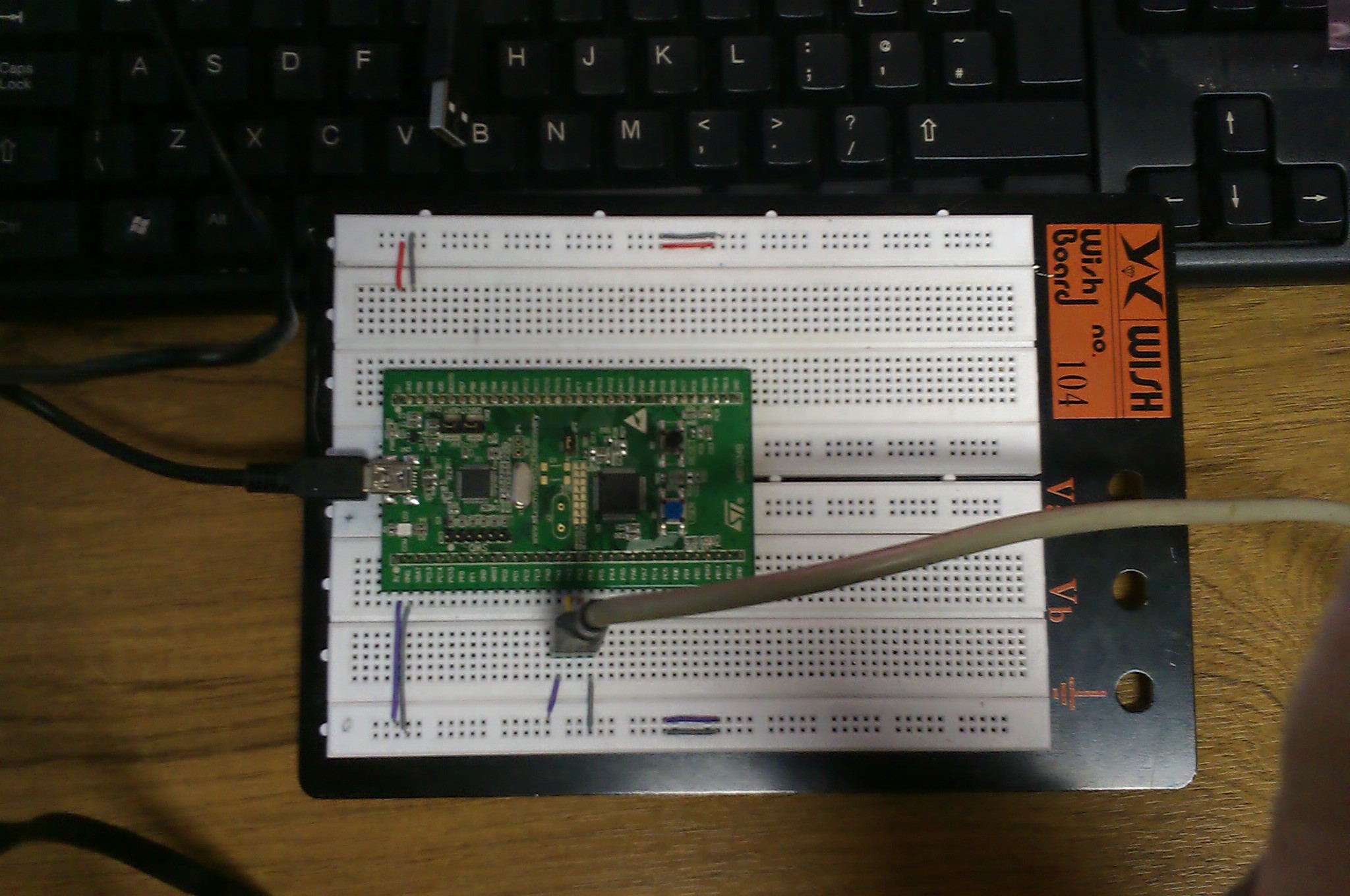 Picture showing breadboard with stm32f0discovery and serial cable attached